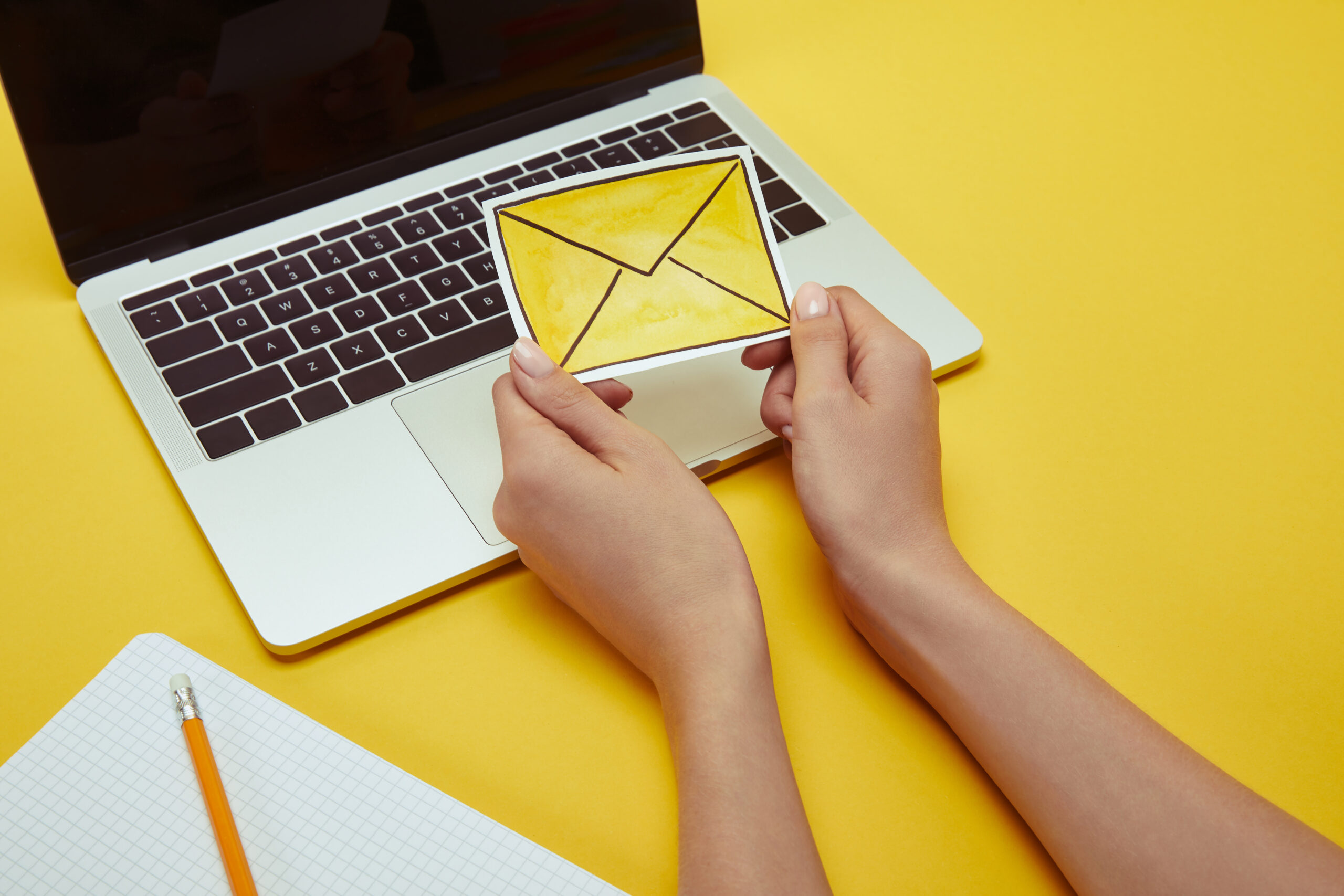 woman holding yellow envelope as metaphor for modern nonprofit email newsletter design